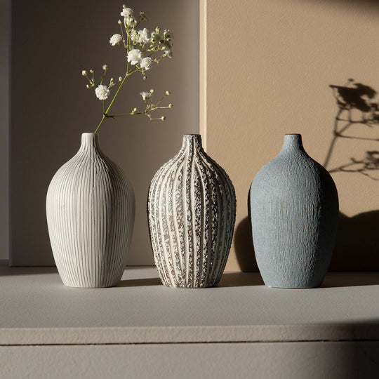 The Elisa ceramic vase by Lindform with their Stone Stripe glaze is a charming decorative vase that looks beautiful as a neutral decorative object on its own