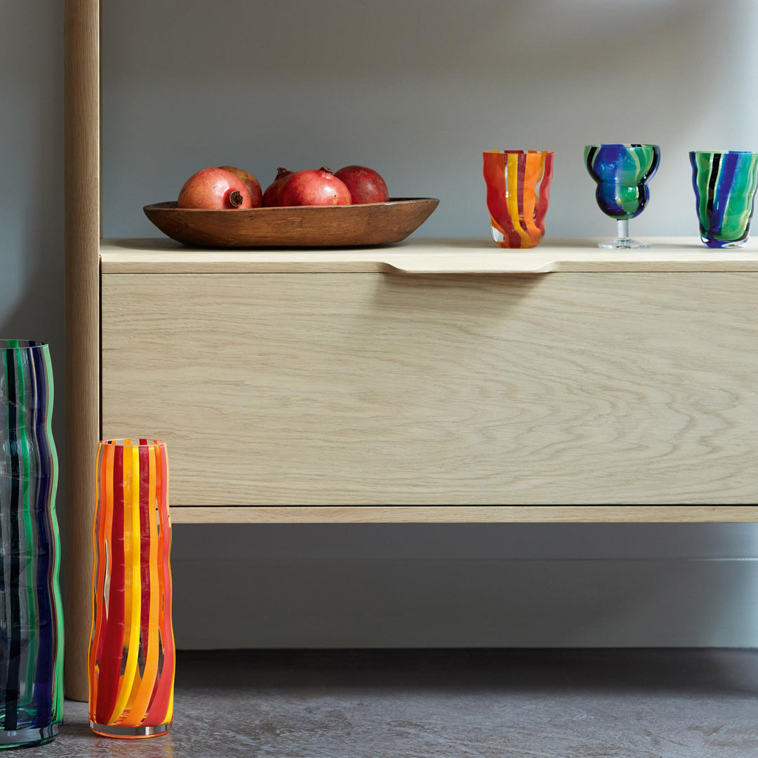 Part of the LSA International Folk Collection, this tall and slender glass Folk Vase has been hand painted with Orange, Red and Yellow stripes for bright and bold impact.&nbsp;