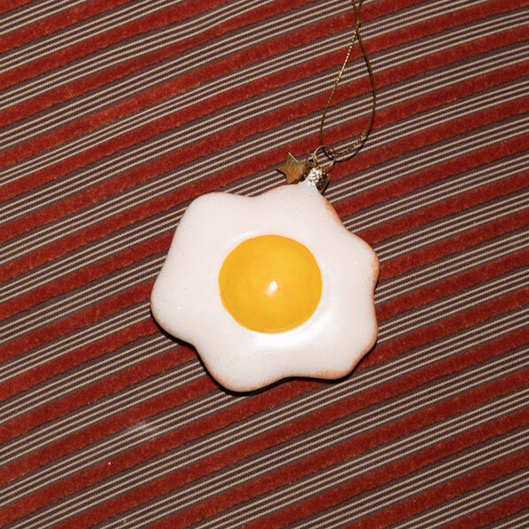 Inject some sparkly fun into your Christmas tree with this hand painted and mouth blown glass Fried Egg&nbsp;ornamental Christmas tree decoration by Vondels.