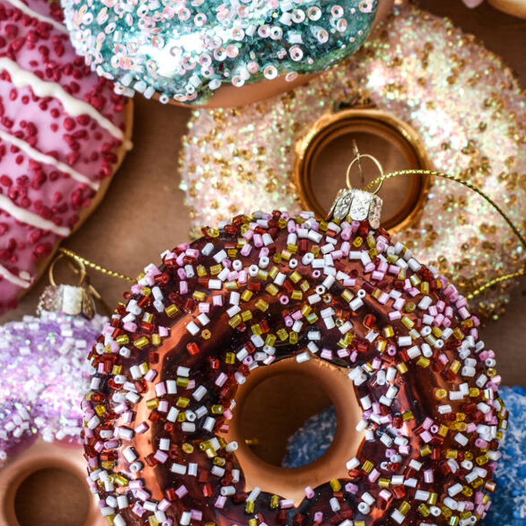 Inject some sparkly fun into your Christmas tree with this hand painted and mouth blown glass Gold Donut ornamental Christmas tree decoration by Vondels