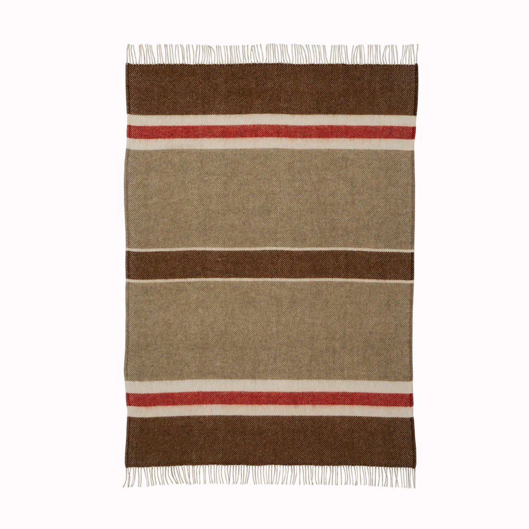 The 'Gotland Stripe' throw by Klippan in Red Stripe is a neutral cream and brown blanket with a hot red stripe. A warm and super soft throw to curl up under for a bit of added warmth