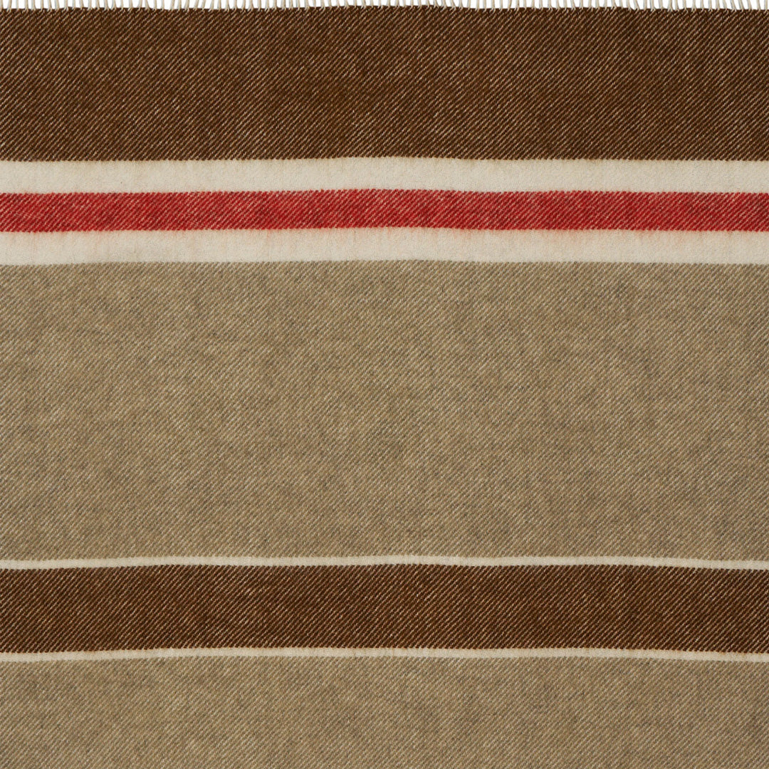 The 'Gotland Stripe' throw by Klippan in Red Stripe is a neutral cream and brown blanket with a hot red stripe. A warm and super soft throw to curl up under for a bit of added warmth