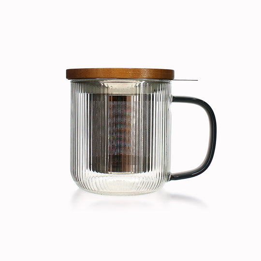 Tea for one in a borosilicate glass teapot mug with graphite grey handle, by French brand Ogo Living. Topped with a wooden lid to keep your tea warm while it brews.