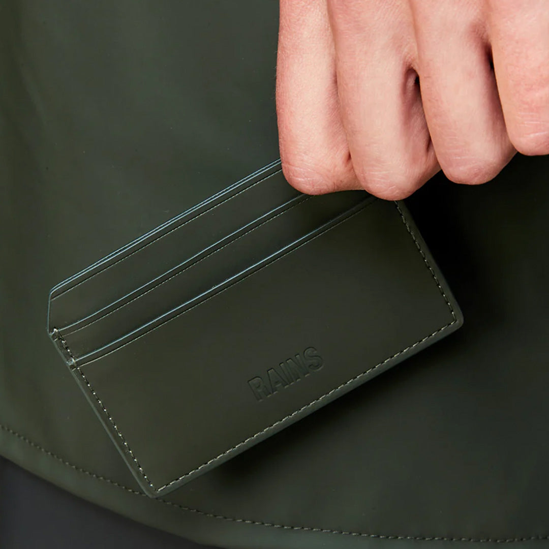 Rains Card Holder in Black, held by model for scale