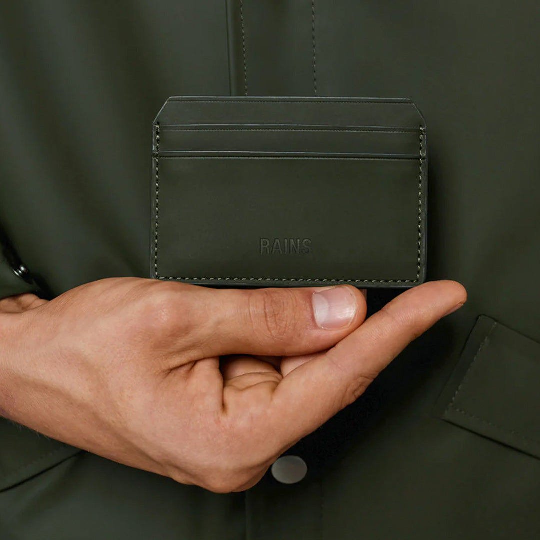 Rains Card Holder in Black, held by model for scale