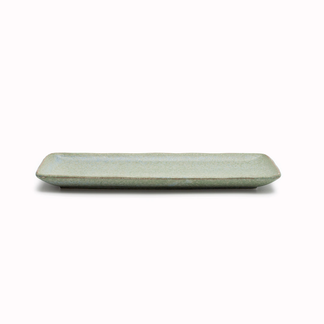 The Green Fade collection features a lush, forest green tone with button-flower blue highlights and an edge of light brown, focussing on simple, practical shapes with a subtle matt finish. Each piece has a unique speckled pattern determined by its position in the kiln during the firing process