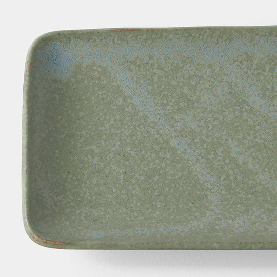 The Green Fade collection features a lush, forest green tone with button-flower blue highlights and an edge of light brown, focussing on simple, practical shapes with a subtle matt finish. Each piece has a unique speckled pattern determined by its position in the kiln during the firing process