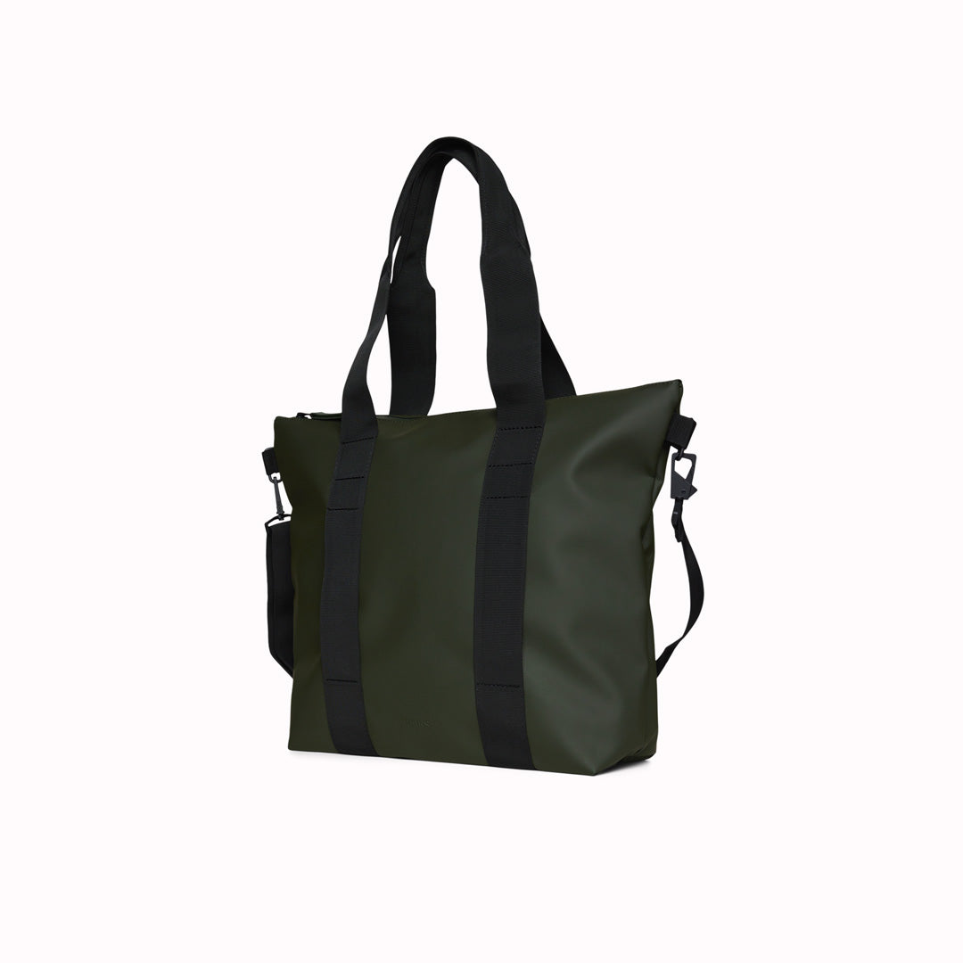 Rains' Green Tote Bag Mini W3 is a waterproof tote bag and an ideal companion for shopping trips as well as commuting to the office. Functional design elements include a full length coated zip for added water protection, which opens up to reveal a spacious main compartment. Made from Rains’ signature waterproof fabric, engineered for strength, durability and a smooth feel.
