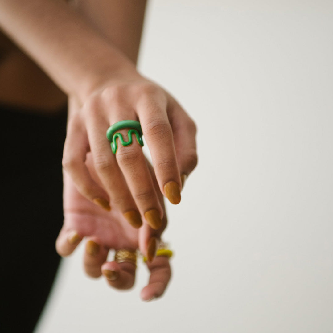 As worn by model, Grete is a green handblown glass ring, handmade by Eyland Jewellery, who produce contemporary and colourful pieces of costume jewellery.