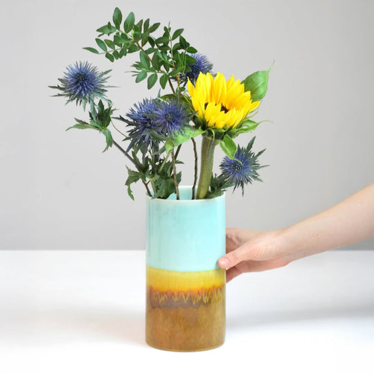 Extra Large Porcelain cylinder vase from London based SGW Lab, glazed in shades of pistachio green, indigo on an earthy natural base.