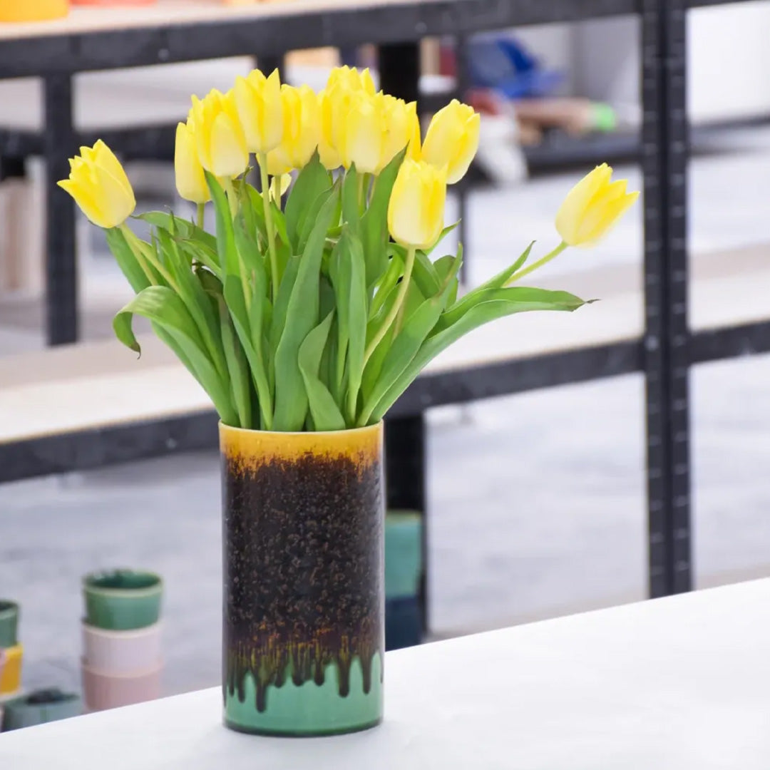 Extra Large Porcelain cylinder vase from London based SGW Lab, glazed in shades of pistachio green, indigo on an earthy natural base.