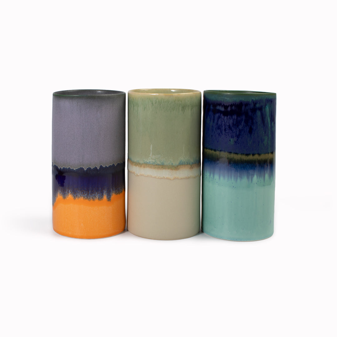 Extra Large Porcelain cylinder vase from London based SGW Lab, glazed in shades of pistachio green, indigo on an earthy natural base.