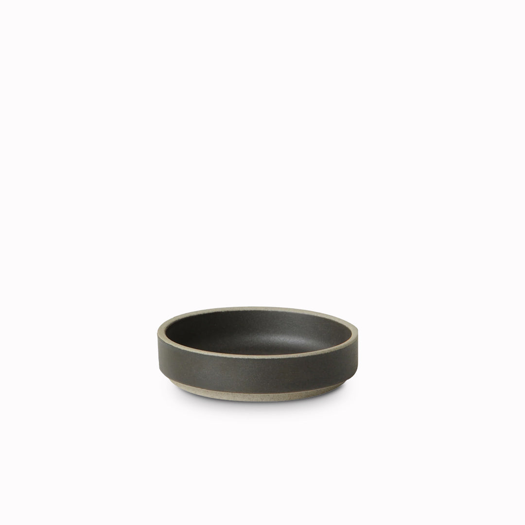 Matt black porcelain plate by Hasami Porcelain is a stackable serving plate with high rimmed edge, suitable for use as a dinner plate or a serving plate for sharing dishes or sides to accompany a meal