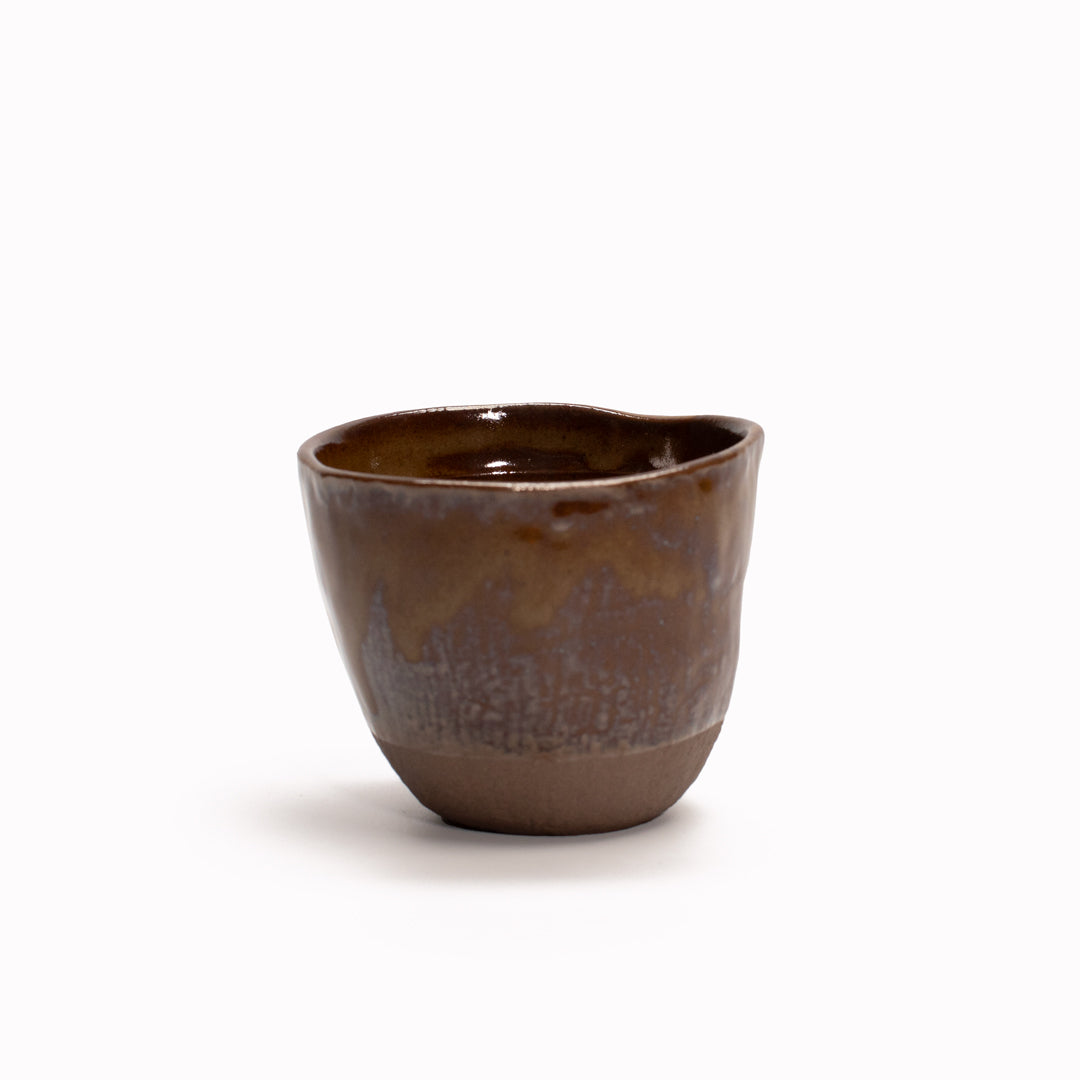 The Hazel Lopsided Tea-mug from Made in Japan is 7cm high and 200ml capacity. Made of 'Minoyaki' earthenware and hand finished in Gifu prefecture, Japan.