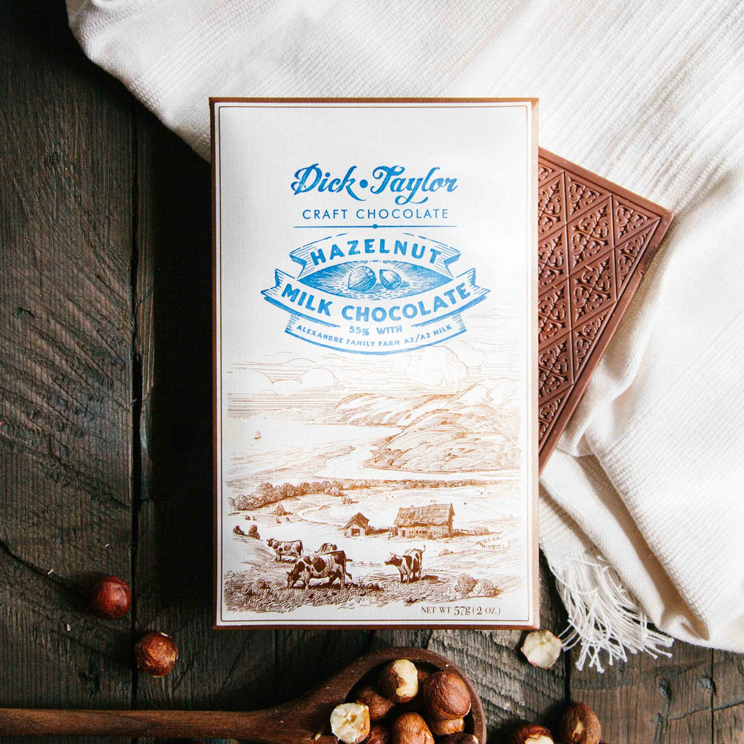 Bean-to-bar milk chocolate with roasted hazelnuts, blending creamy cocoa with nutty crunch in a small-batch craft chocolate bar.