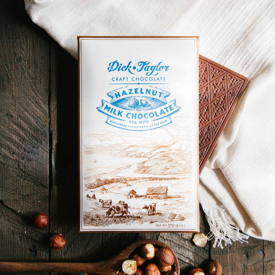Bean-to-bar milk chocolate with roasted hazelnuts, blending creamy cocoa with nutty crunch in a small-batch craft chocolate bar.