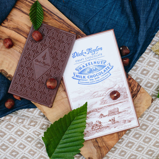 Bean-to-bar milk chocolate with roasted hazelnuts, blending creamy cocoa with nutty crunch in a small-batch craft chocolate bar.
