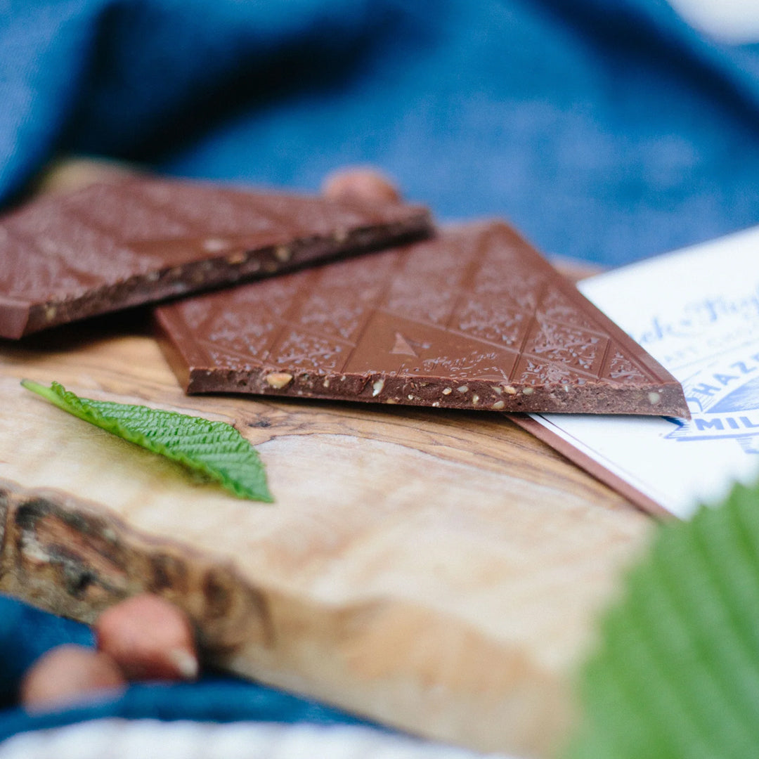 Bean-to-bar milk chocolate with roasted hazelnuts, blending creamy cocoa with nutty crunch in a small-batch craft chocolate bar.