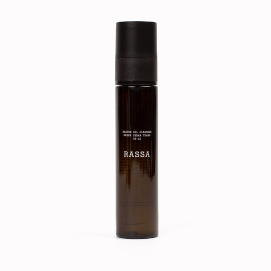Brown bottle with black cap labeled 'RASSA' Heaven Oil Cleanser on a white background