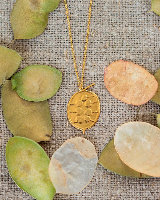 The Honesty Pod necklace is a botanical pendant necklace with charming heart shaped seed detail.
