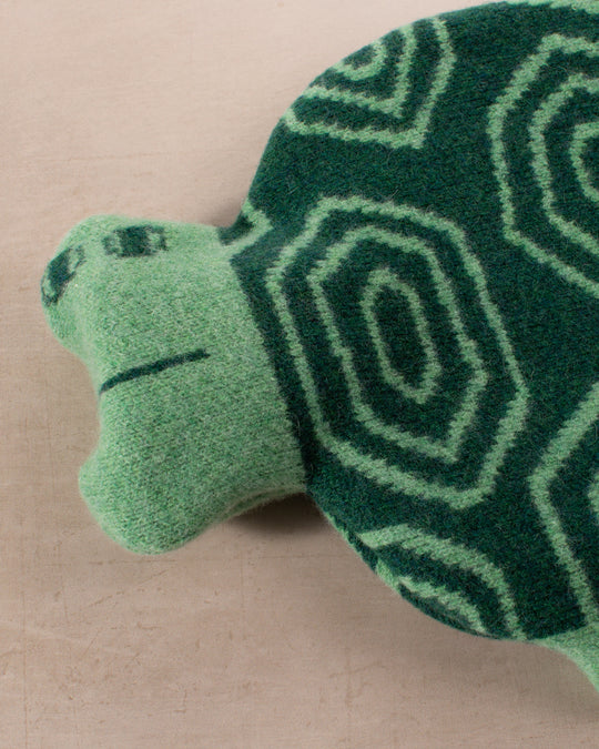 Made in Scotland from 100% lambswool, the Tortoise Hot Water Bottle is a soft and cuddly companion by Donna Wilson. 