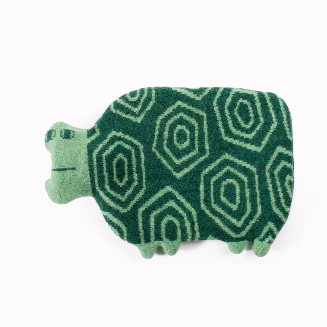 Made in Scotland from 100% lambswool, the Tortoise Hot Water Bottle is a soft and cuddly companion by Donna Wilson. 