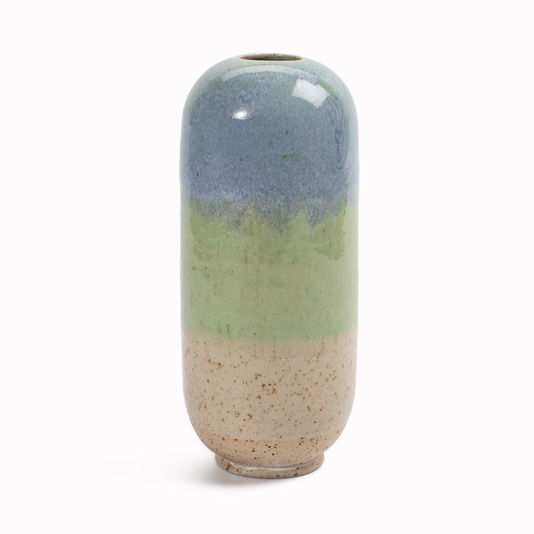 The&nbsp;multi coloured Hummingbird design is hand-thrown in watertight stoneware. Due to the rounded taper at the top of the vase, the glaze melts down the sides of the cylindrical vase mimicking melting ice.