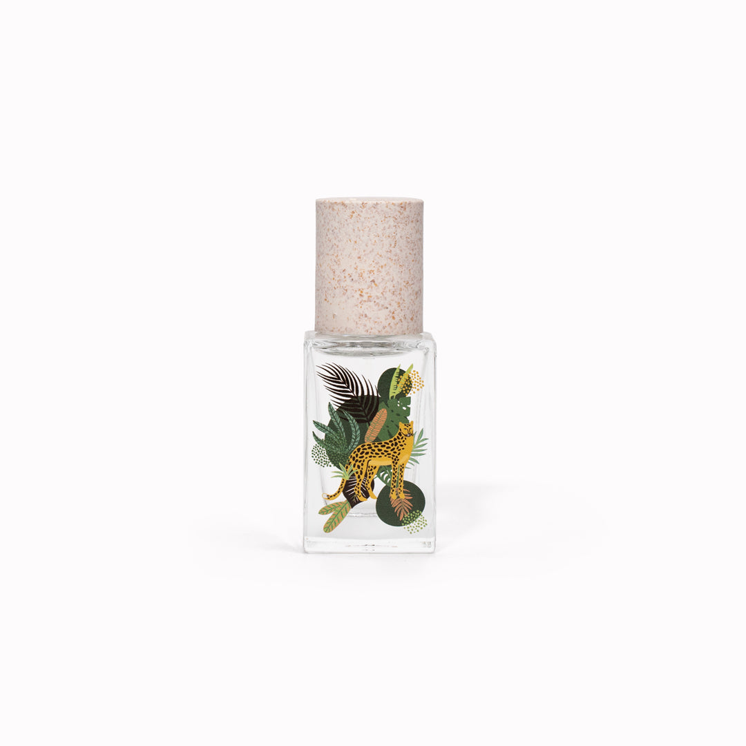 Maison Matine's 'Into the Wild' is a scent inspired by nature, travel and life's adventures, all housed in an illustrative glass bottle. 15ml bottle shown, with leopard and jungle leaves.