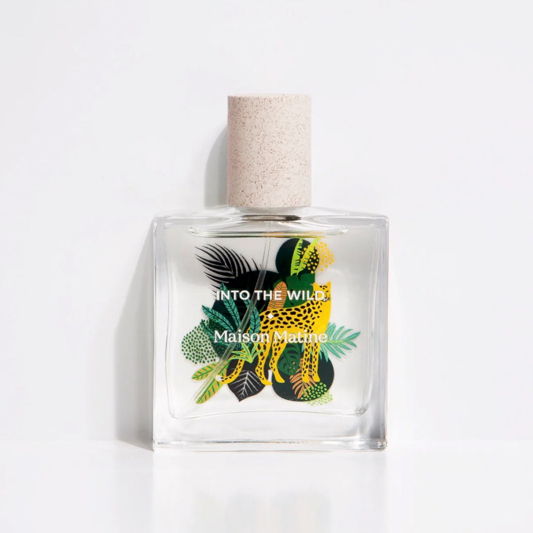 Maison Matine's 'Into the Wild' is a scent inspired by nature, travel and life's adventures, all housed in an illustrative glass bottle. 50ml bottle shown, with leopard and jungle leaves.
