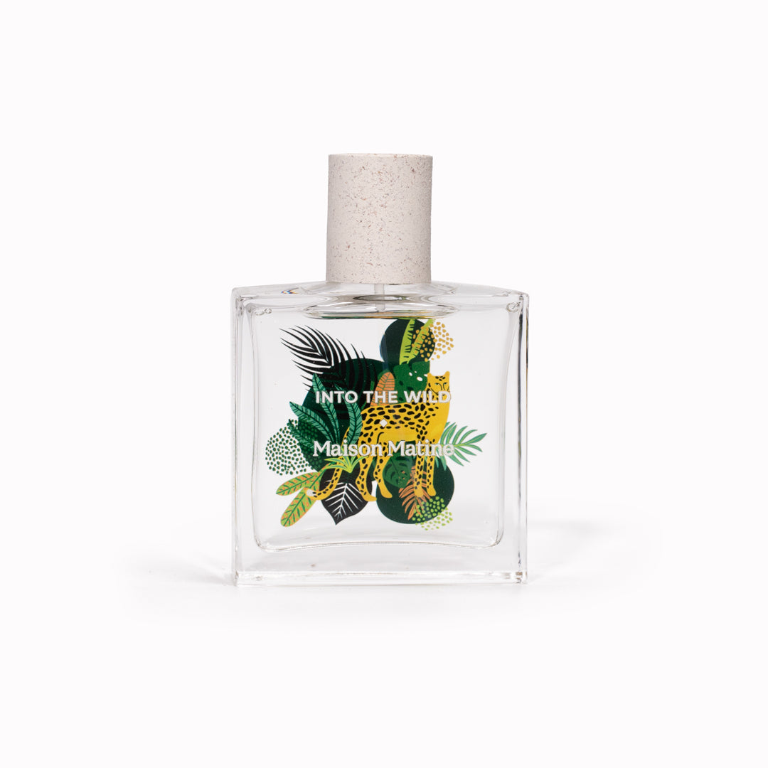 Maison Matine's 'Into the Wild' is a scent inspired by nature, travel and life's adventures, all housed in an illustrative glass bottle. 50ml bottle shown, with leopard and jungle leaves.