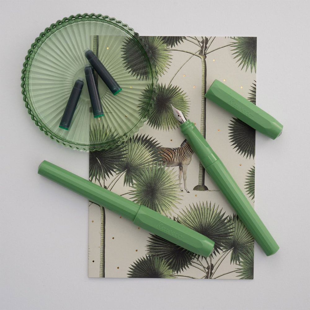 The Kaweco Perkeo rollerball pen in Jungle Green features an ergonomic grip, octagonal cap and hexadecagon shaped barrel. - Lifestyle
