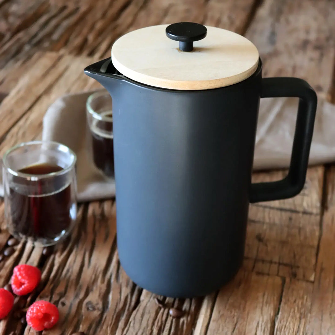 Matt Black porcelain French Press with stainless steel plunger. Contemporary styling and matt black porcelain make this French Press an easy 'go to' essential for your morning coffee Lifestyle image on table