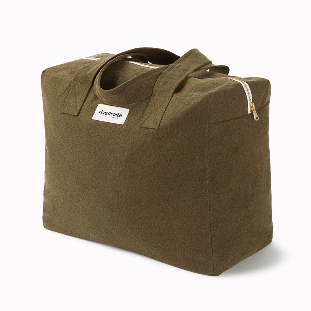 Khaki/Green Célestins bag from Parisian brand Rive Droite is a chic canvas overnight travel bag with enough room for night away (or 2 if you pack light!) Viewed from an angle