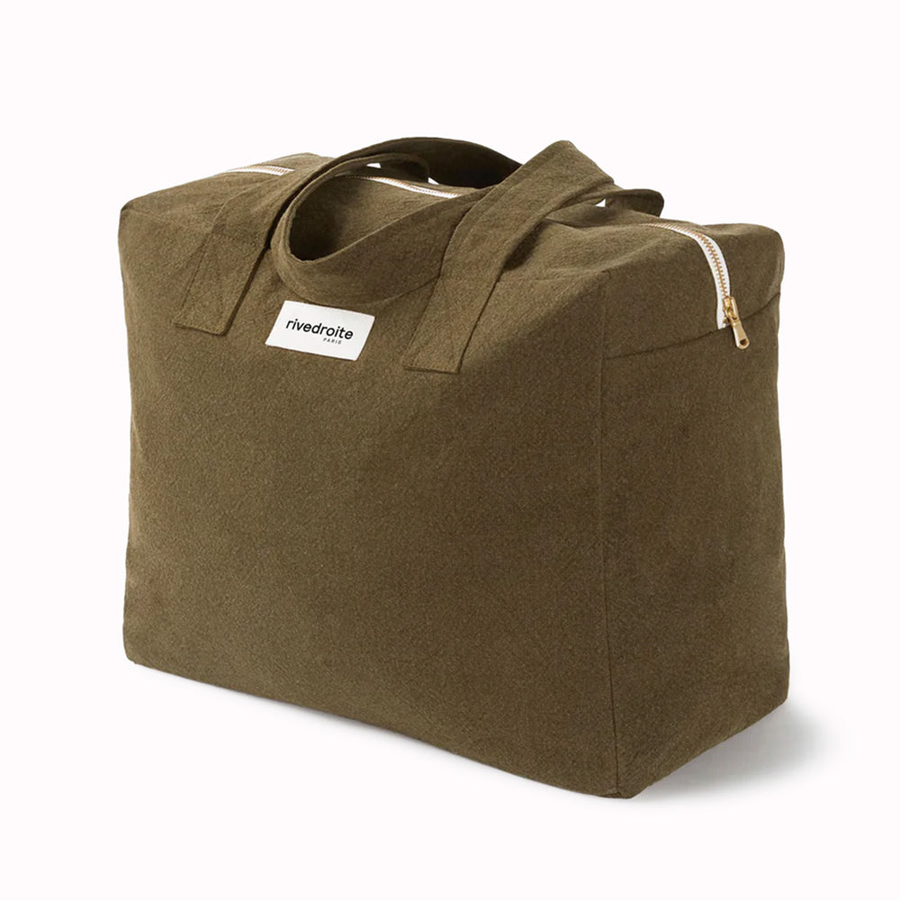 Khaki/Green Célestins bag from Parisian brand Rive Droite is a chic canvas overnight travel bag with enough room for night away (or 2 if you pack light!) Viewed from an angle
