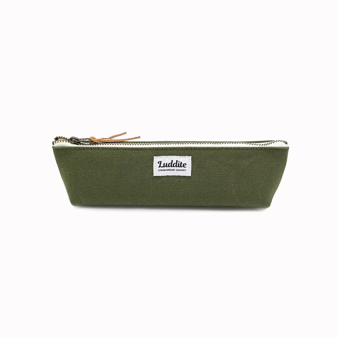 Boat shaped pen and pencil case by Japanese stationery brand Luddite.  The durable and tactile pencil case features a zipper along the length of the pencil case allows easy access to the items inside.