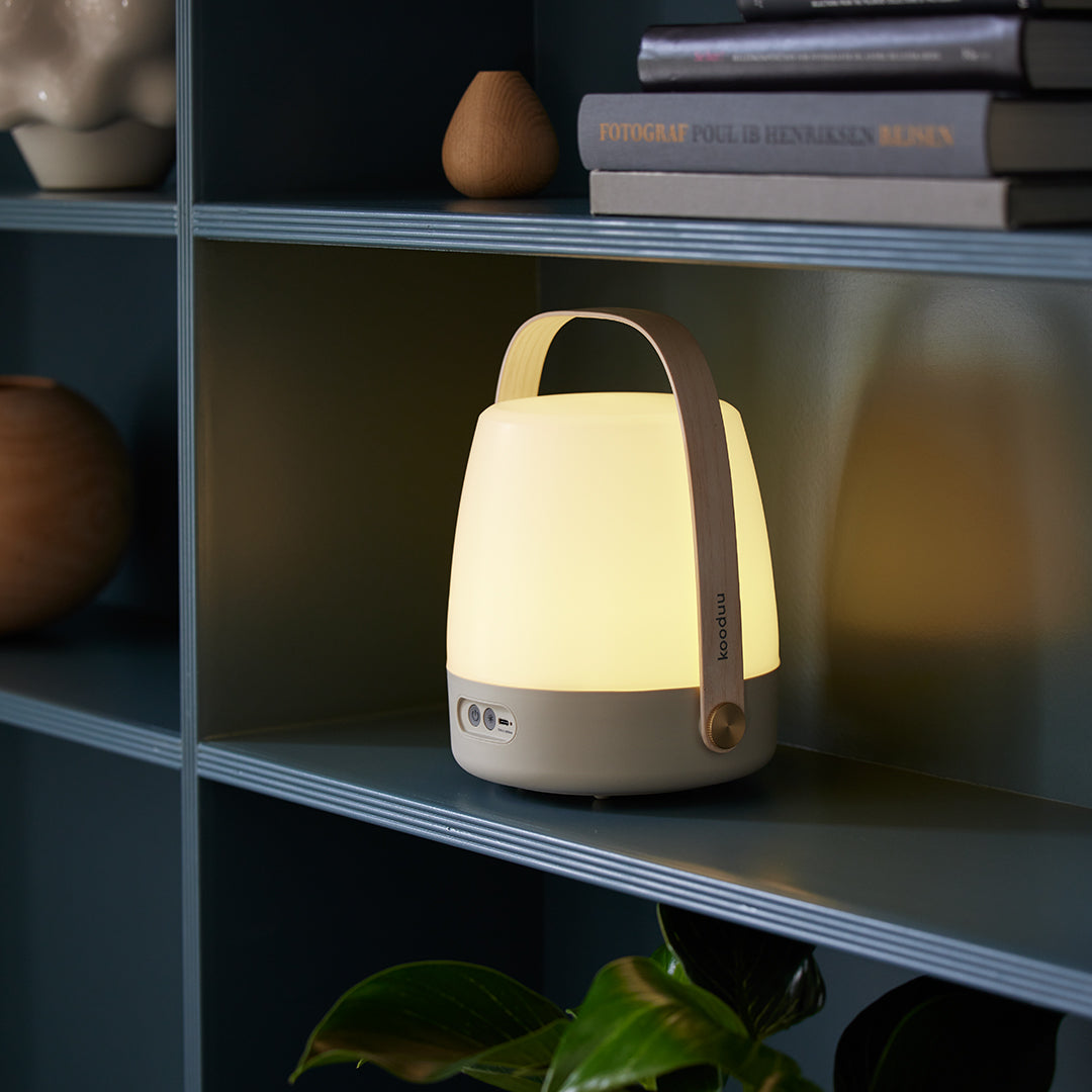 On shelf, The Lite-Up in Earth from Kooduu is a battery operated portable light with a pleasing wooden carry handle and Scandinavian interior feel.