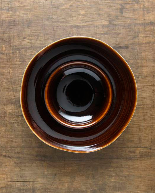 A rich brown glazed Japanese Mino ware bowl with a wide rim and hollowed out centre - suitable for serving pasta, starter dishes or soup.
