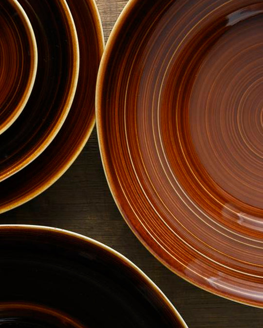 A rich brown glazed Japanese Mino ware bowl with a wide rim and hollowed out centre - suitable for serving pasta, starter dishes or soup.
