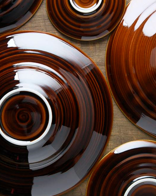 A rich brown glazed Japanese Mino ware bowl with a wide rim and hollowed out centre - suitable for serving pasta, starter dishes or soup.