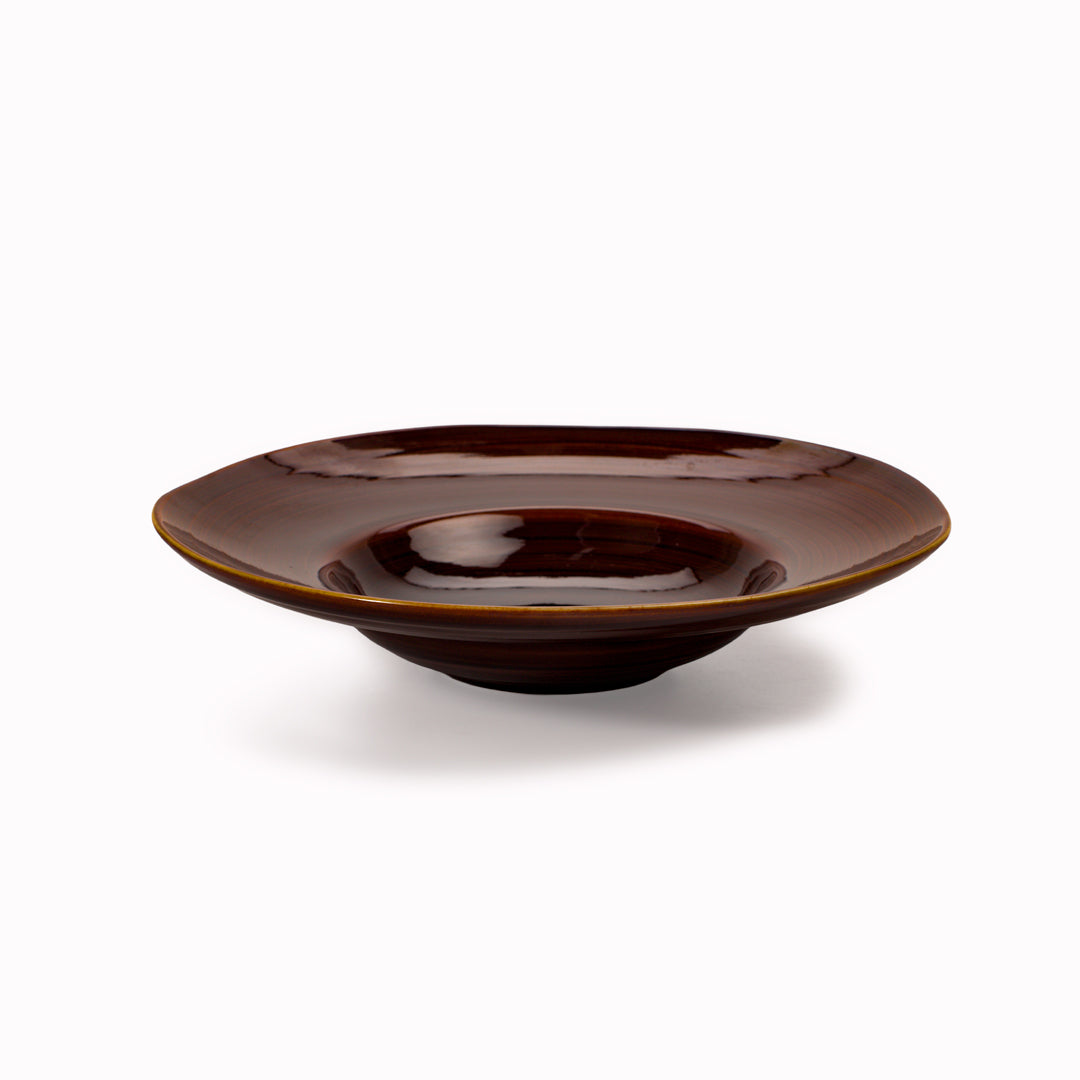 A rich brown glazed Japanese Mino ware bowl with a wide rim and hollowed out centre - suitable for serving pasta, starter dishes or soup.