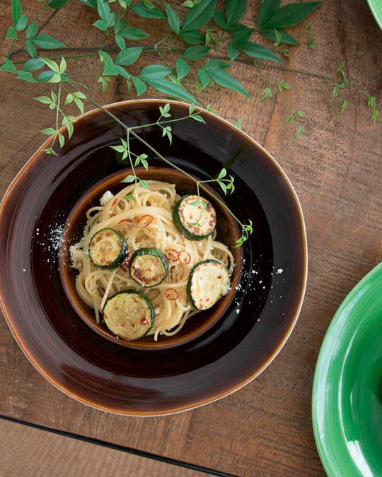 A rich brown glazed Japanese Mino ware bowl with a wide rim and hollowed out centre - suitable for serving pasta, starter dishes or soup.
