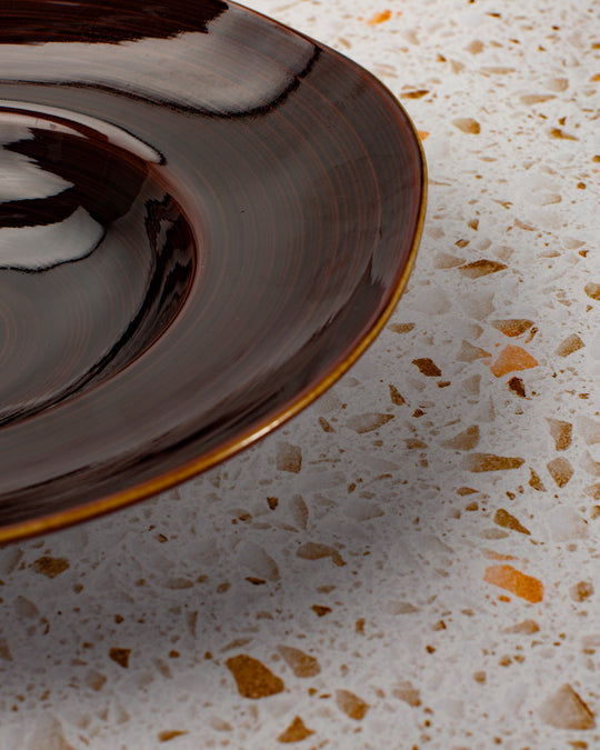 A rich brown glazed Japanese Mino ware bowl with a wide rim and hollowed out centre - suitable for serving pasta, starter dishes or soup.
