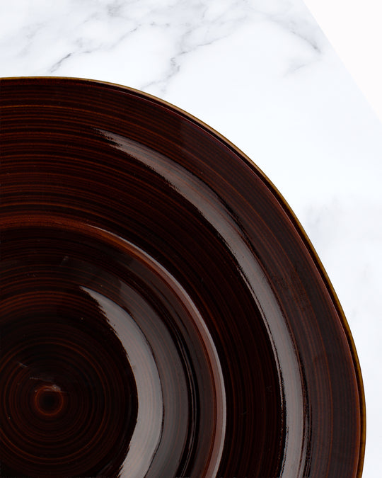 A rich brown glazed Japanese Mino ware bowl with a wide rim and hollowed out centre - suitable for serving pasta, starter dishes or soup.