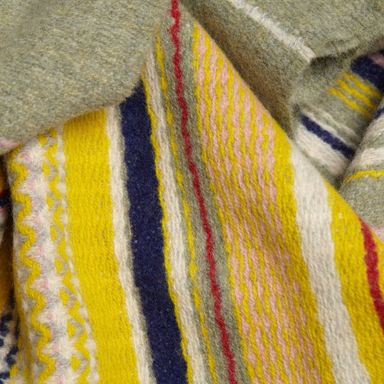 The Lavanda lambswool Scarf by Wallace and Sewell showcases the intricate craft of textile design, blending traditional techniques with modern aesthetics