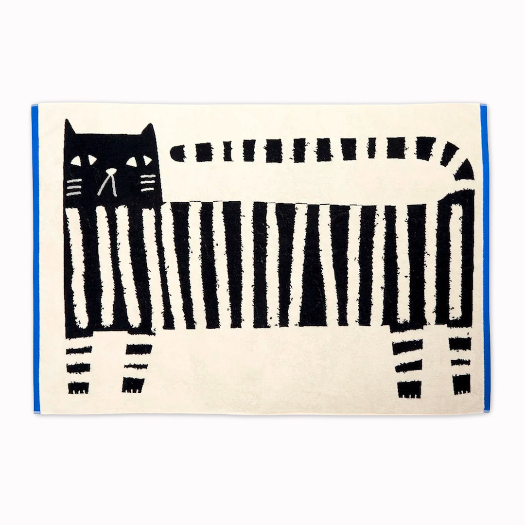 The Donna Wilson Lazy Cat Textile collection brings a playful, design-led twist to everyday bathroom linens. Simple graphic striped cat illustration with a bold blue edge binding.