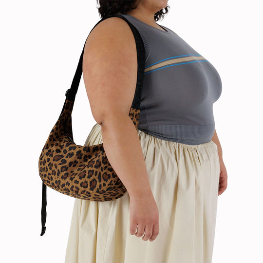 The Medium Crescent Bag in Leopard print from Baggu is a stylish and versatile accessory that can complement any outfit.