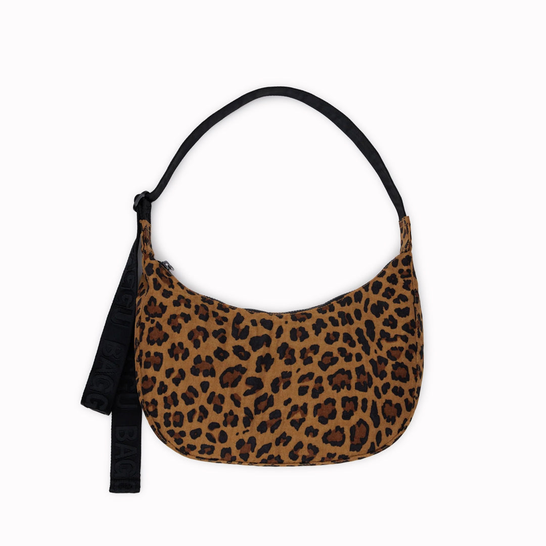 The Medium Crescent Bag in Leopard print from Baggu is a stylish and versatile accessory that can complement any outfit.