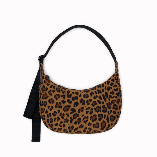The Medium Crescent Bag in Leopard print from Baggu is a stylish and versatile accessory that can complement any outfit.