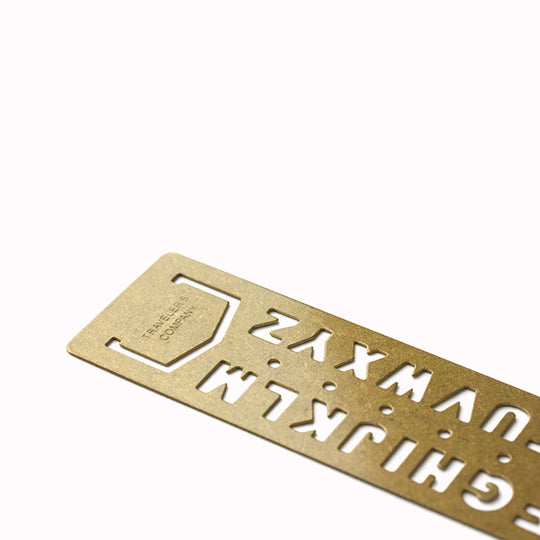 Made from solid brass with a tactile weight and finish, this piece works as both a bookmark and an alphabet template you can slot into your notebook or planner.