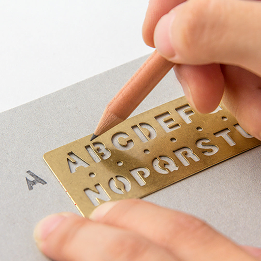 Made from solid brass with a tactile weight and finish, this piece works as both a bookmark and an alphabet template you can slot into your notebook or planner.